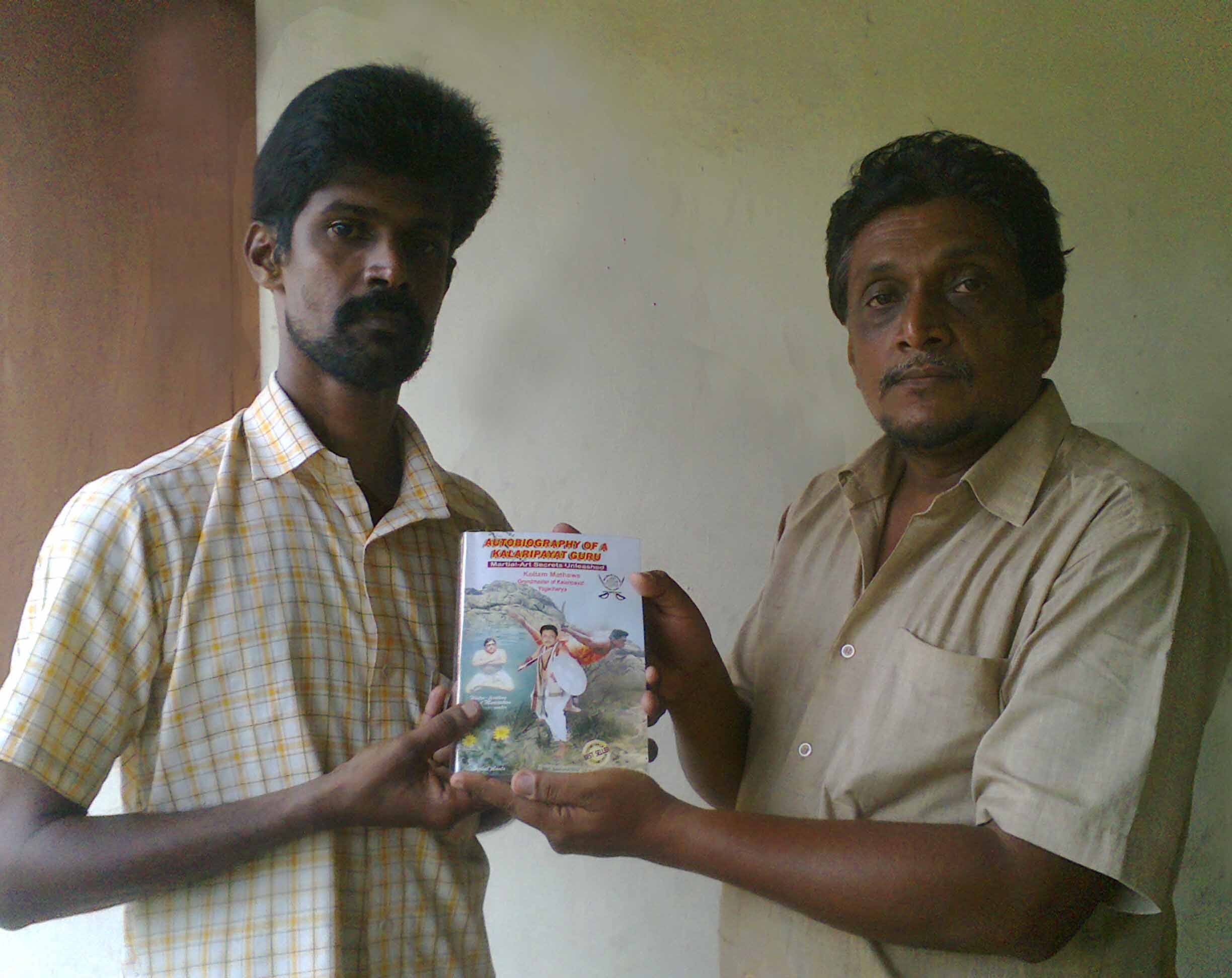 Mathew gurukkal giving 1st copy to Pramod Gurukkal